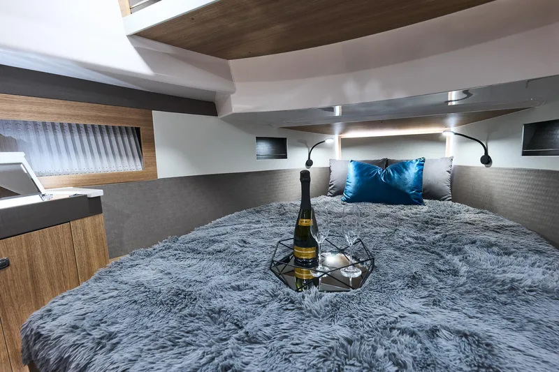  Yacht Photos Pics Luxurious Northman 1300 yacht interior with cozy bed, champagne, and elegant decor, 2025 model.