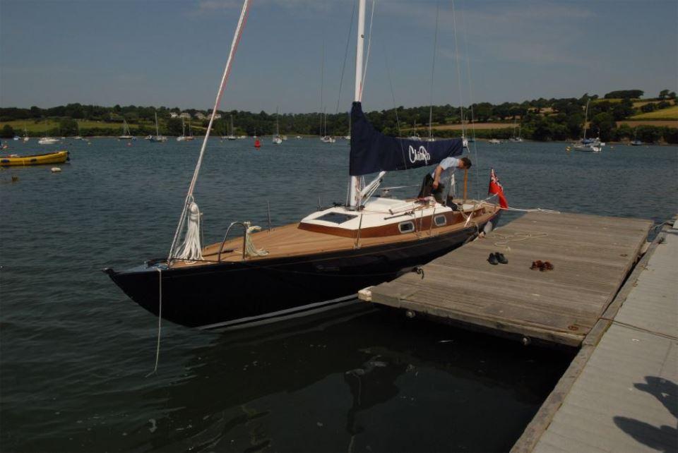Sleek 2025 Rustler 33 sailboat docked on a sunny day.