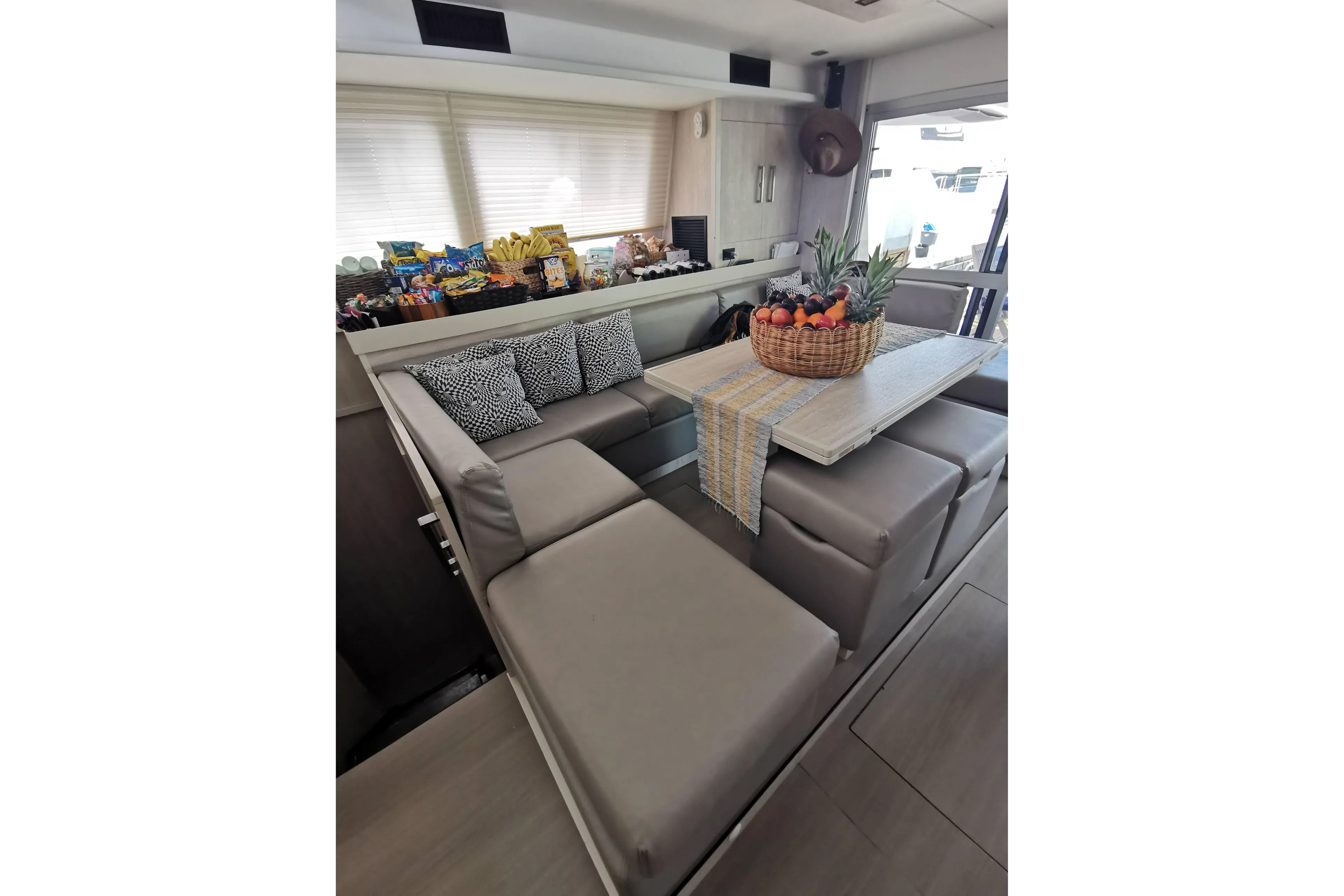 Luxurious Leopard 58 yacht interior with cozy seating, fruit basket, and snacks, 2020 model.