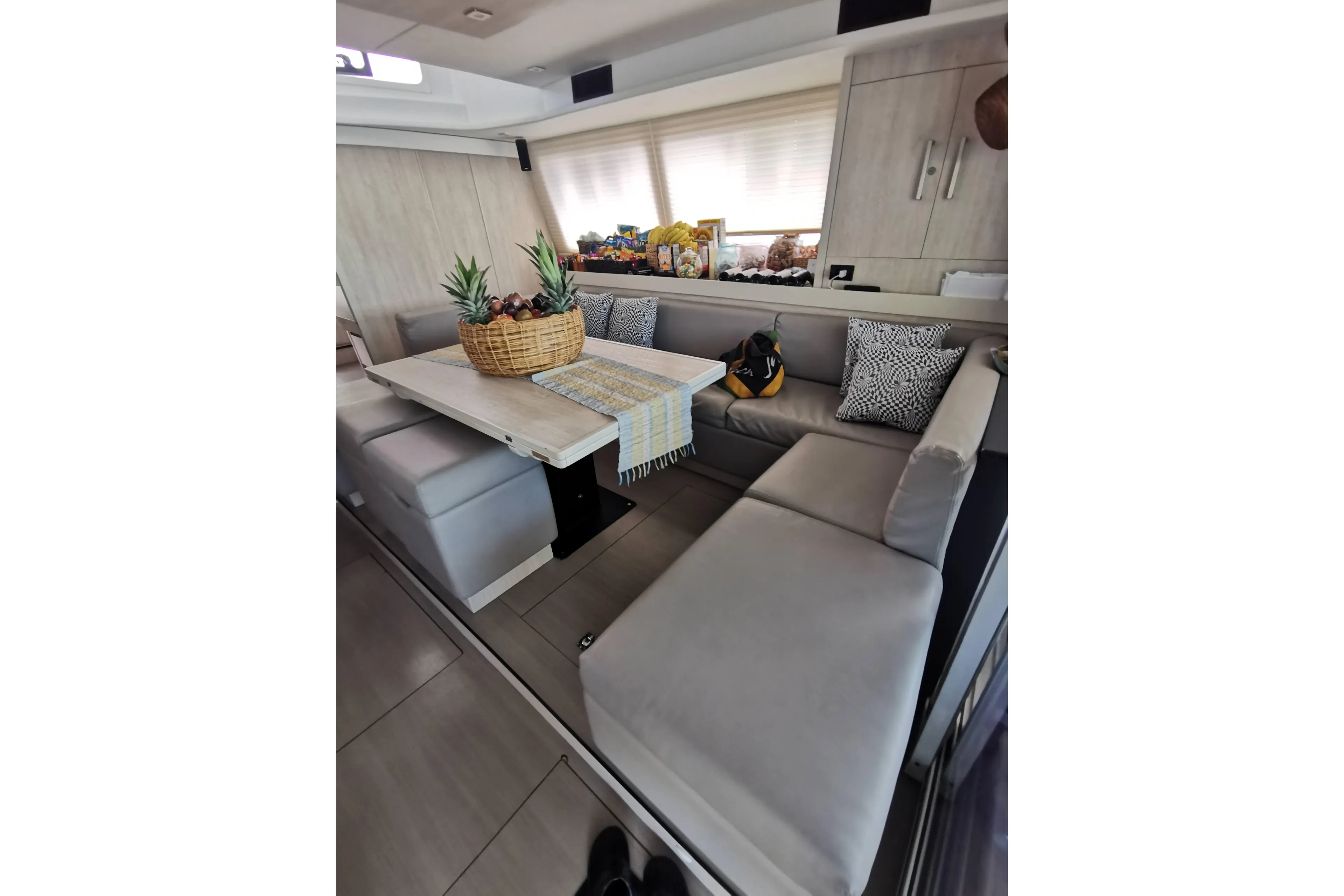 Luxurious Leopard 58 yacht interior with cozy seating and decorative fruit basket, 2020 model.