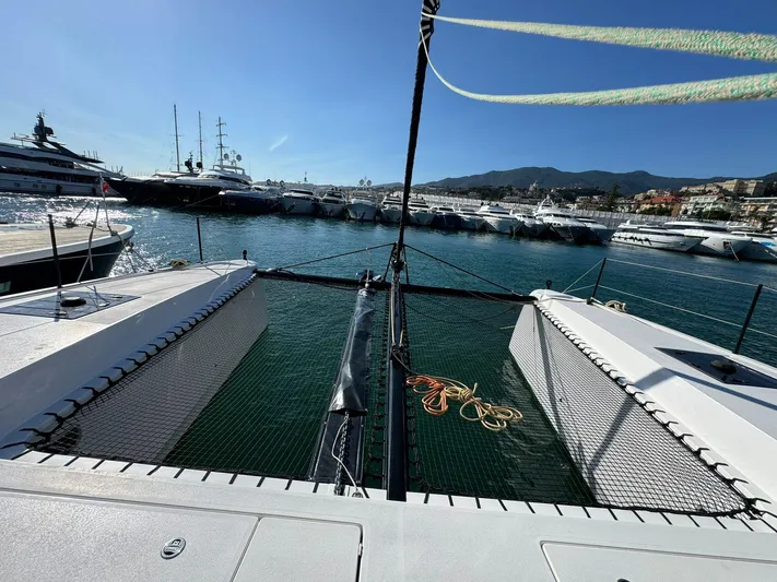  Yacht Photos Pics 2023 Outremer 55 catamaran docked in a marina with clear blue skies.