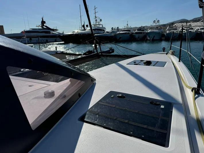  Yacht Photos Pics Outremer 55 yacht deck, 2023 model, docked in a marina with other luxury boats.