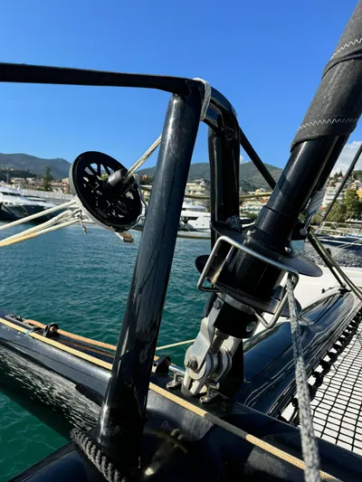  Yacht Photos Pics 2023 Outremer 55 yacht detail, showcasing rigging and deck against a marina backdrop.