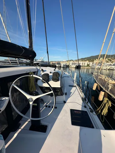  Yacht Photos Pics 2023 Outremer 55 sailboat docked, featuring sleek design and modern steering wheel.