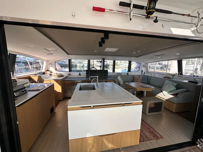  Yacht Photos Pics Luxurious interior of 2023 Outremer 55 catamaran with modern kitchen and spacious seating area.