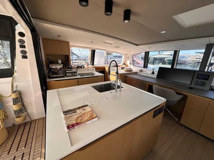  Yacht Photos Pics Modern kitchen interior of 2023 Outremer 55 yacht with sleek design and ample natural light.