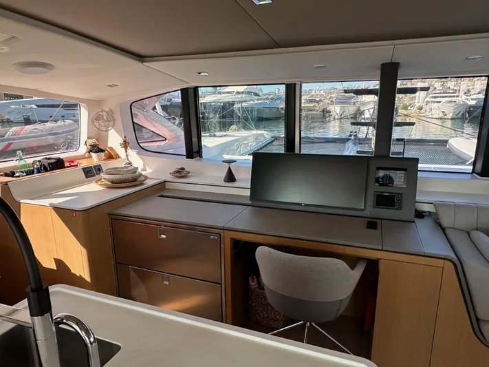  Yacht Photos Pics Modern interior of 2023 Outremer 55 yacht with sleek design and large windows.