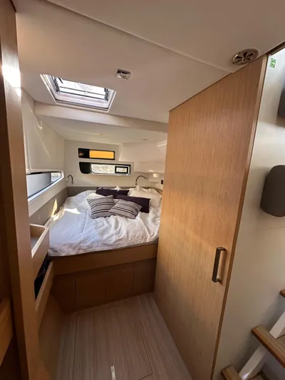  Yacht Photos Pics Interior of 2023 Outremer 55 yacht, featuring a cozy bedroom with skylight.