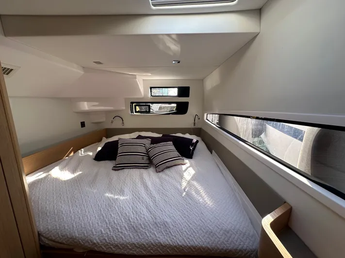  Yacht Photos Pics Luxurious cabin interior of 2023 Outremer 55 yacht with modern bedding and ample natural light.