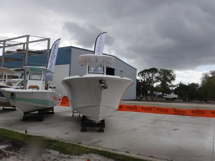  Yacht Photos Pics 2025 NauticStar 292 Legacy boat displayed outdoors under cloudy skies.