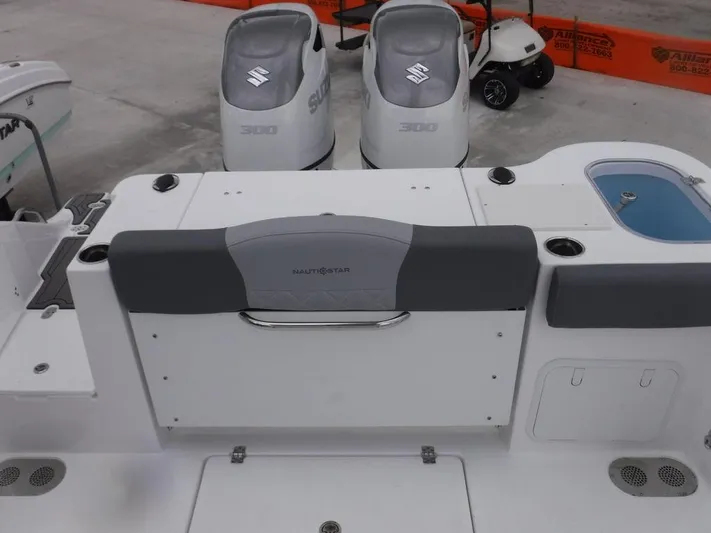  Yacht Photos Pics 2025 NauticStar 292 Legacy boat with dual Suzuki engines, rear seating, and storage compartments.