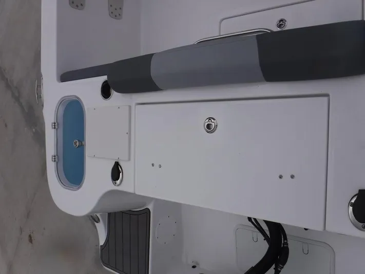  Yacht Photos Pics 2025 NauticStar 292 Legacy boat interior with seating and storage compartments.