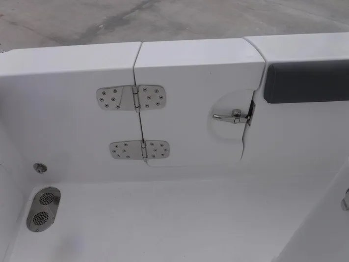  Yacht Photos Pics 2025 NauticStar 292 Legacy boat hinge and latch detail on white surface.