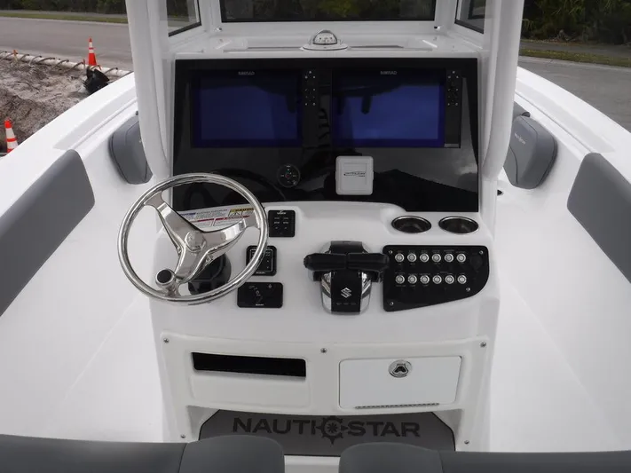  Yacht Photos Pics 2025 NauticStar 292 Legacy boat dashboard with dual screens and steering wheel.