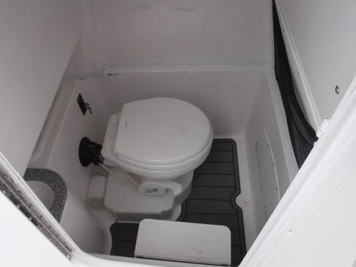  Yacht Photos Pics 2025 NauticStar 292 Legacy boat interior bathroom with toilet and flooring.