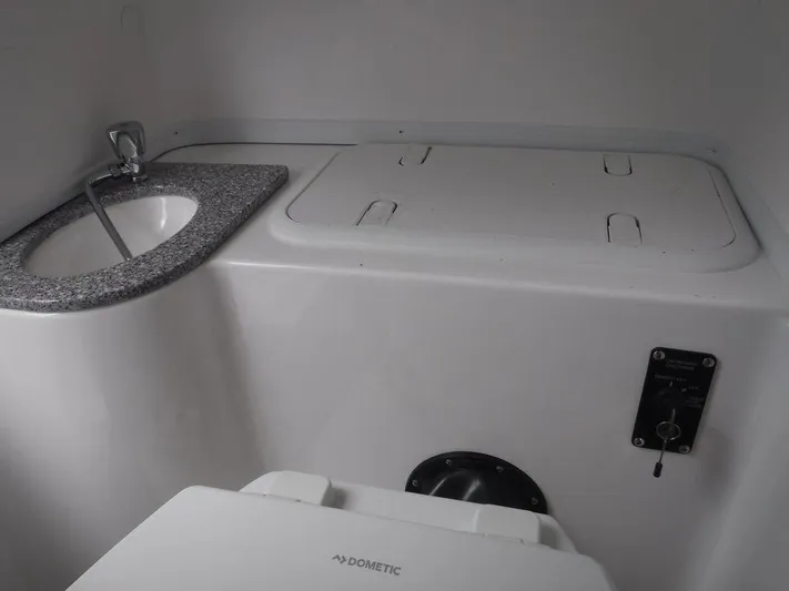  Yacht Photos Pics 2025 NauticStar 292 Legacy boat interior with sink and storage area.