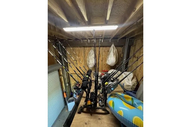 Foam O Yacht Photos Pics Fishing rods stored in a wooden shed, alongside inflatable pool float.