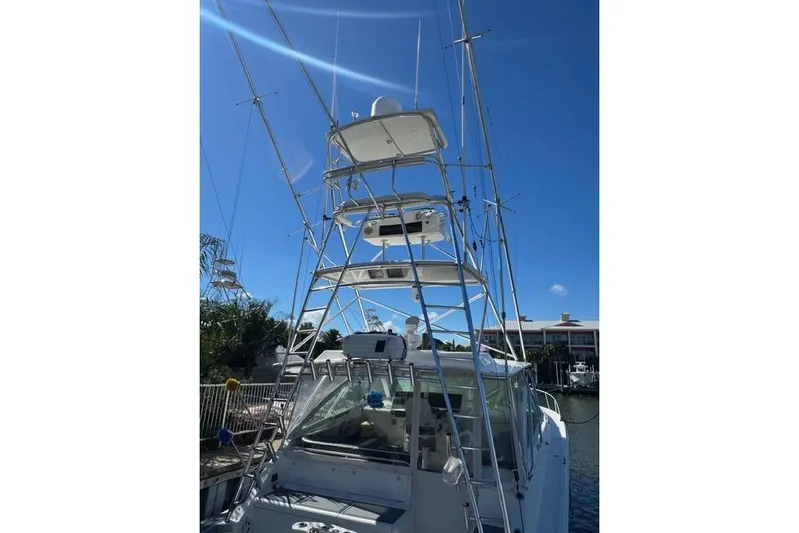 Foam O Yacht Photos Pics 2000 Cabo 45 Express boat with tall tower against clear blue sky.