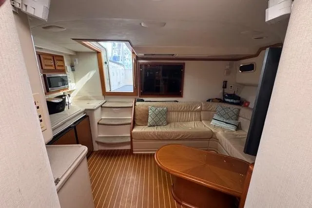 Foam O Yacht Photos Pics Interior of 2000 Cabo 45 Express yacht with cozy seating and kitchenette.