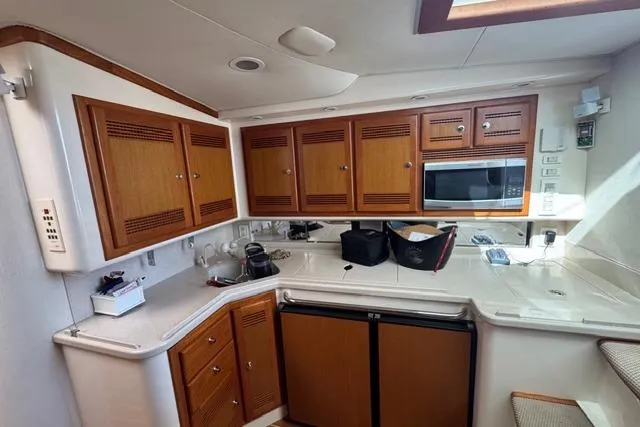 Foam O Yacht Photos Pics 2000 Cabo 45 Express yacht kitchen with wooden cabinets and modern appliances.
