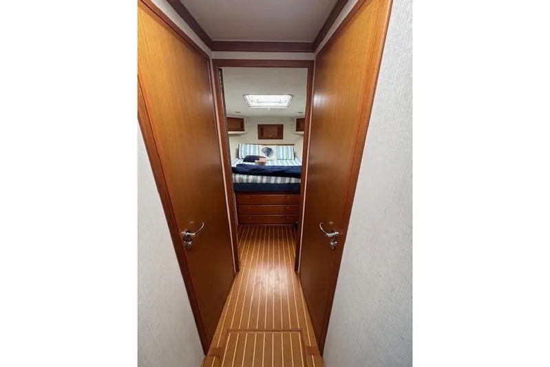 Foam O Yacht Photos Pics Interior view of 2000 Cabo 45 Express yacht cabin with wooden flooring and cozy bed.