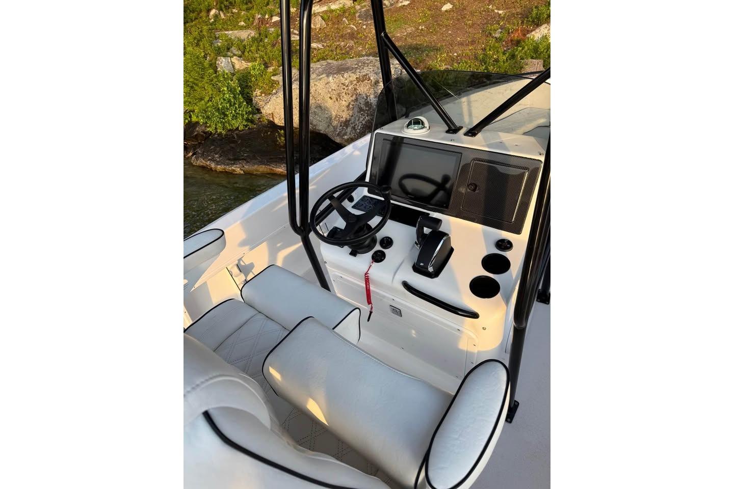 Boat cockpit with steering wheel, controls, and seating; Concept 27, 2004 model.