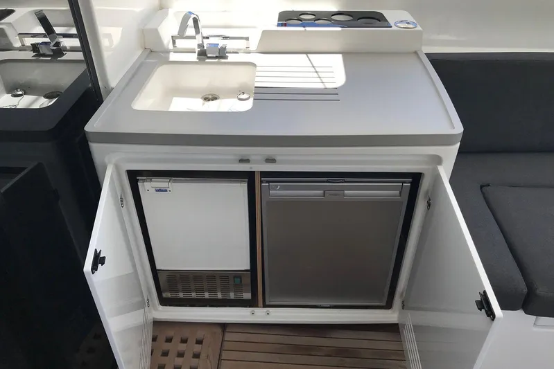  Yacht Photos Pics Compact kitchen area on 2019 Lagoon 50 yacht with sink, fridge, and storage.