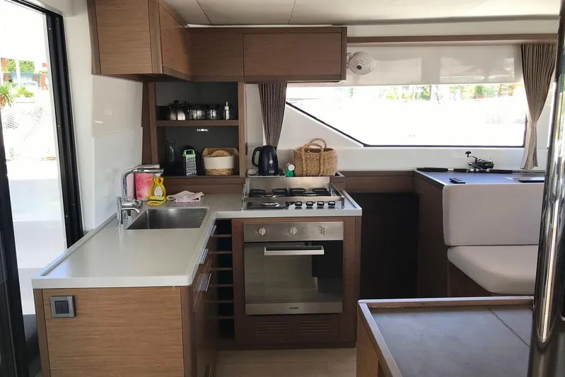 Yacht Photos Pics Modern kitchen interior of 2019 Lagoon 50 yacht with sleek wood cabinetry and appliances.