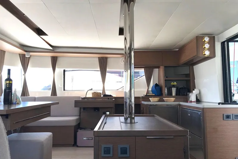  Yacht Photos Pics Luxurious interior of 2019 Lagoon 50 catamaran with modern kitchen and dining area.