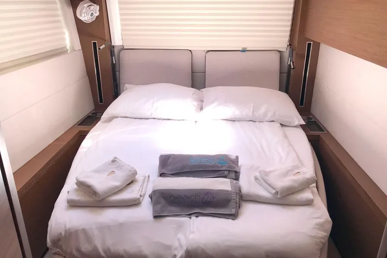  Yacht Photos Pics Luxurious cabin interior of 2019 Lagoon 50 yacht with neatly arranged bed and towels.