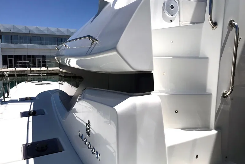 Yacht Photos Pics 2019 Lagoon 50 yacht, sleek white exterior, docked at marina under clear blue sky.