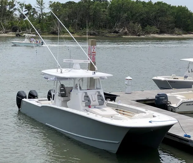  Yacht Photos Pics 2020 Tideline 365 boat docked, featuring dual outboard motors and sleek design.