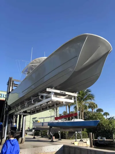  Yacht Photos Pics 2020 Tideline 365 boat on lift under clear blue sky.