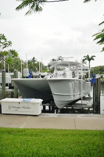  Yacht Photos Pics 2020 Tideline 365 boat docked at marina with lush greenery and palm trees.