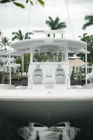  Yacht Photos Pics 2020 Tideline 365 boat docked, featuring Garmin equipment, surrounded by palm trees and waterfront homes.