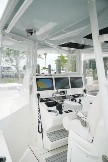  Yacht Photos Pics Interior of a 2020 Tideline 365 boat with advanced navigation systems and steering wheel.