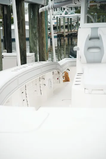  Yacht Photos Pics White Tideline 365 boat interior at dock, featuring seating and storage, 2020 model.