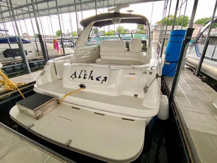  Yacht Photos Pics 1999 Sea Ray 400 Sundancer docked in marina, rear view with seating area.