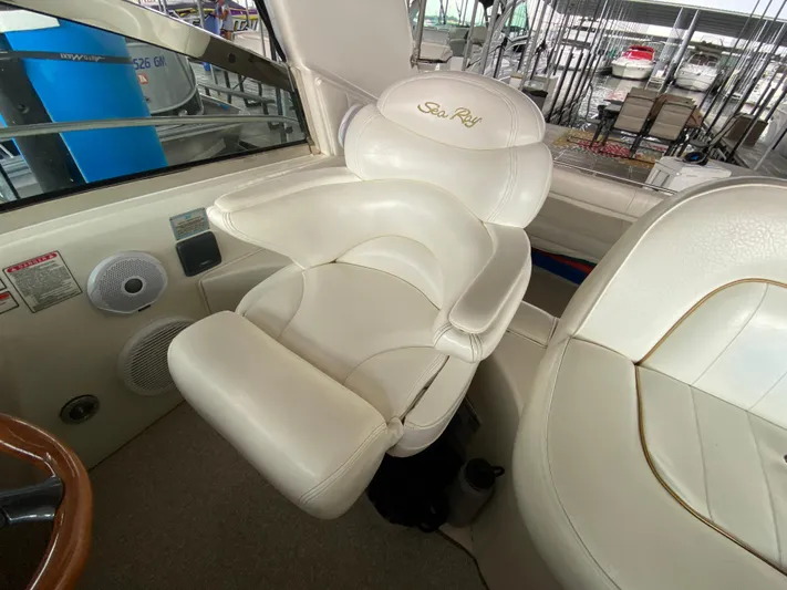  Yacht Photos Pics Captain's chair on 1999 Sea Ray 400 Sundancer yacht, featuring white leather upholstery.