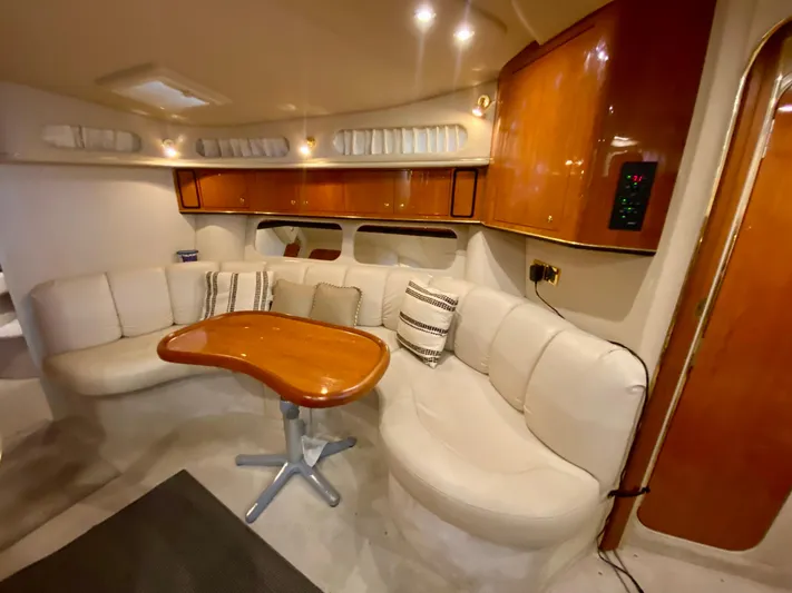  Yacht Photos Pics Luxurious interior of 1999 Sea Ray 400 Sundancer yacht with plush seating and wooden table.