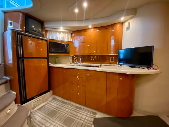  Yacht Photos Pics Luxurious 1999 Sea Ray 400 Sundancer yacht kitchen with wood cabinetry and modern appliances.