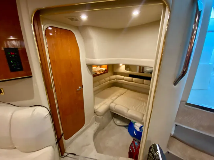  Yacht Photos Pics Interior cabin of 1999 Sea Ray 400 Sundancer yacht with cozy seating and wooden door.