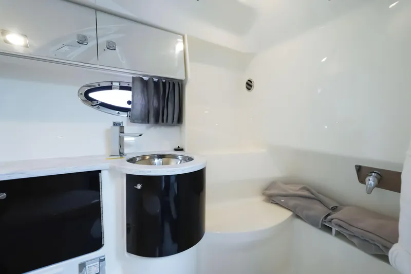 Have A Nice Life Yacht Photos Pics 2017 Formula 370 Super Sport bathroom interior with sink, storage, and porthole.