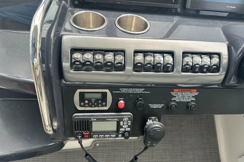 Have A Nice Life Yacht Photos Pics Control panel of a 2017 Formula 370 Super Sport boat with switches and radio.