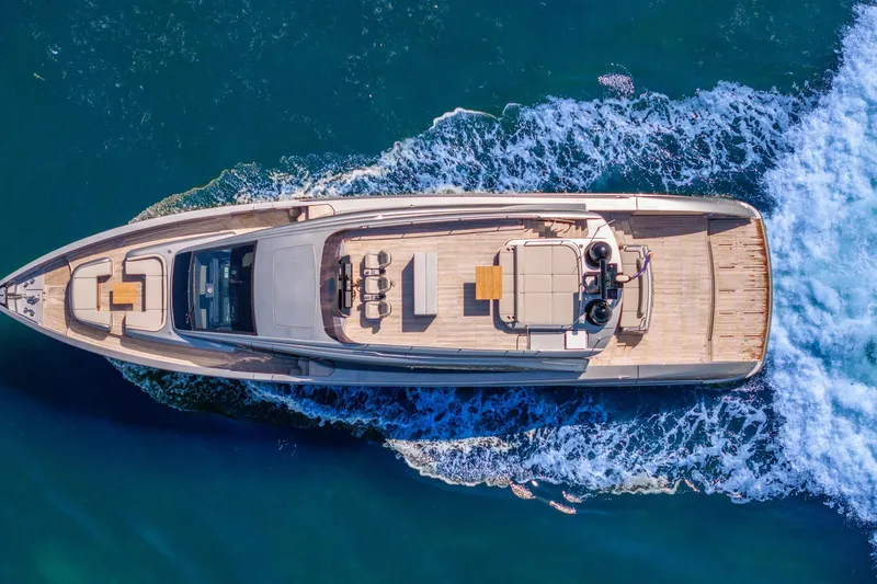 Ciao Yacht Photos Pics Aerial view of 2025 Pershing GTX 80 yacht cruising on blue ocean waters.