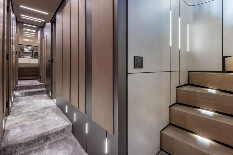 Ciao Yacht Photos Pics Luxurious interior of 2025 Pershing GTX 80 yacht with modern staircase and hallway lighting.