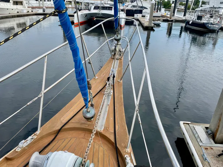  Yacht Photos Pics Bow of a 1974 custom center cockpit sailboat docked at a marina.
