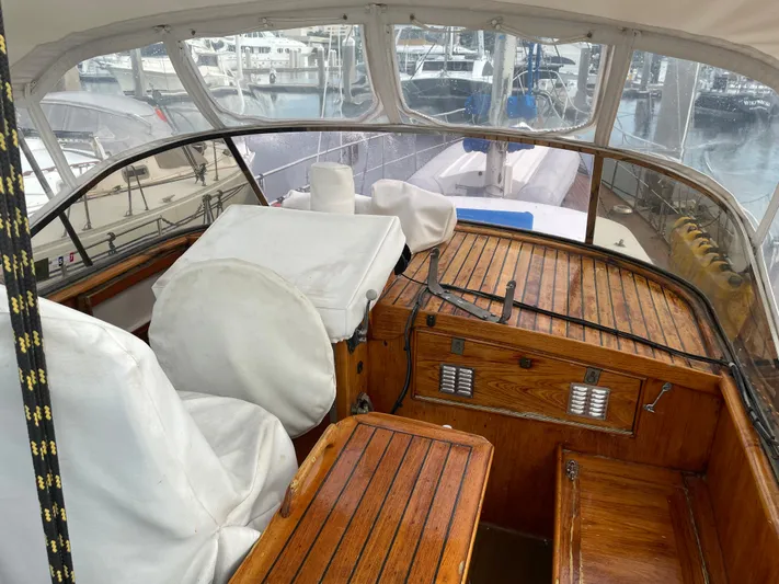  Yacht Photos Pics 1974 Custom Center Cockpit boat with wooden interior, docked at a marina.