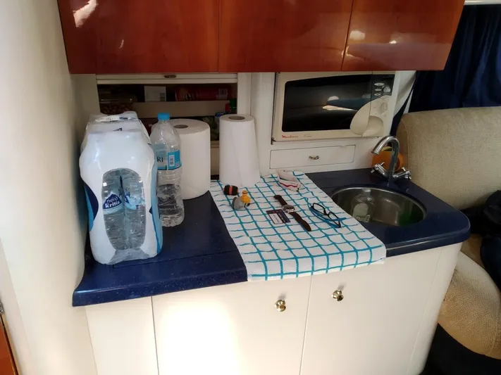  Yacht Photos Pics Compact kitchen area in a 2000 Cranchi Endurance 39 yacht with sink and microwave.