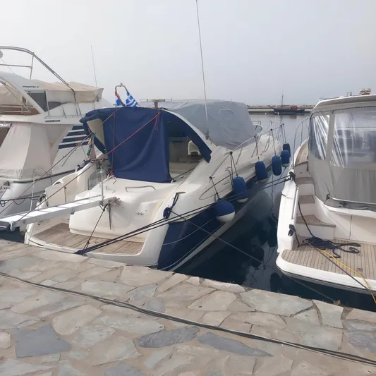  Yacht Photos Pics 2000 Cranchi Endurance 39 yacht docked at marina, covered with blue canopy.